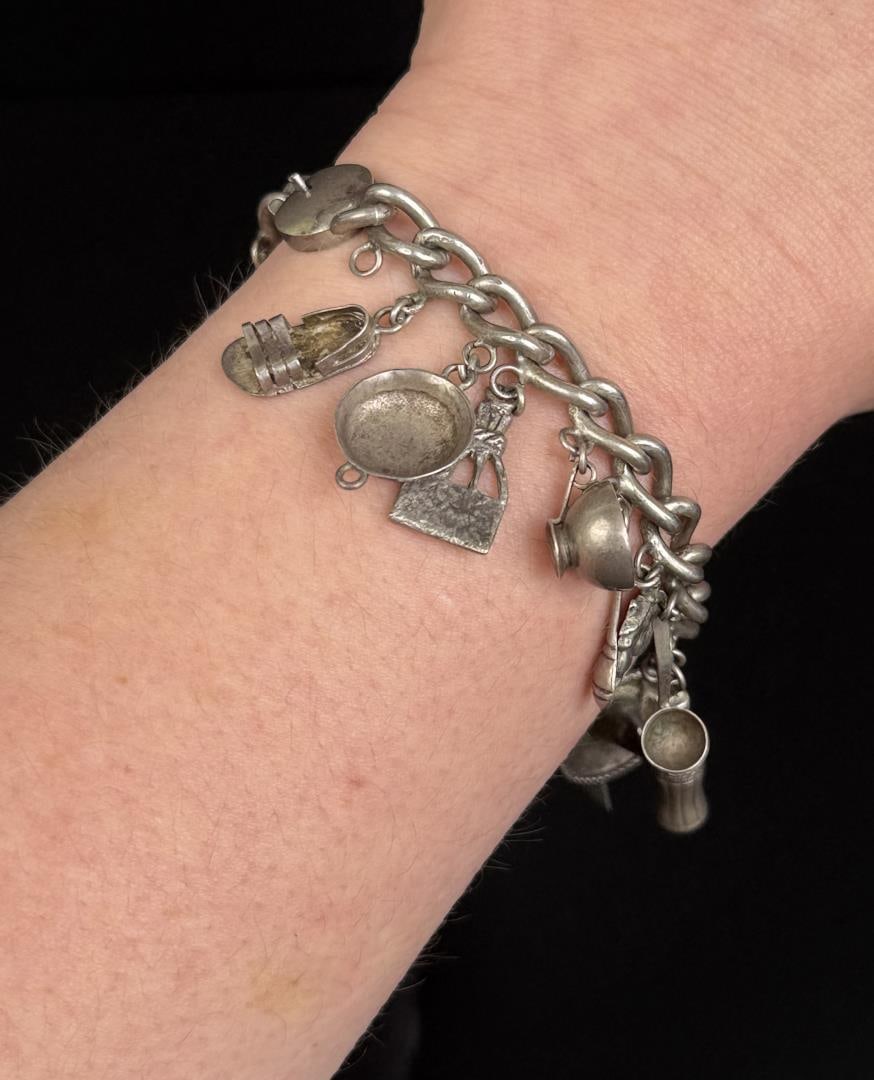 Sterling Silver Charm Bracelet: 40.33 grams. 7 3/8" long when laid flat.