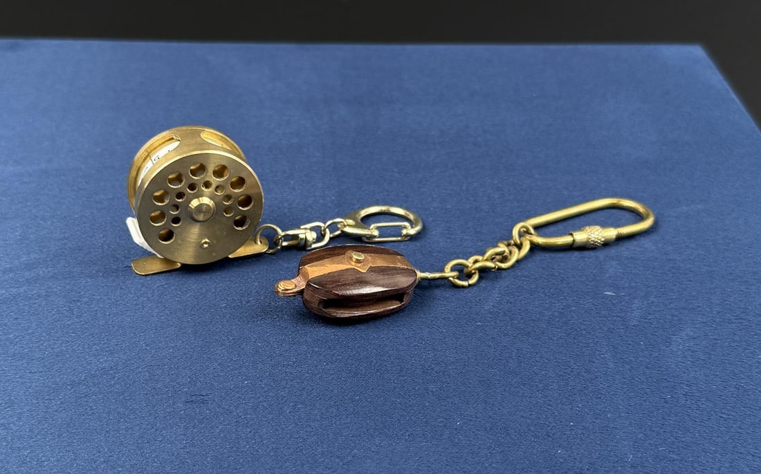 Brass Fishing Reel Measuring Tape Keychains: Largest is 2 7/8" by 1 1/4" by 7/8".