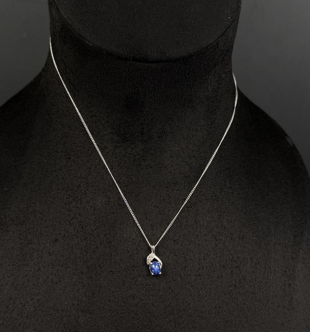 14k White Gold Star Sapphire Necklace: 1.97 grams. 9 3/8" long as displayed.