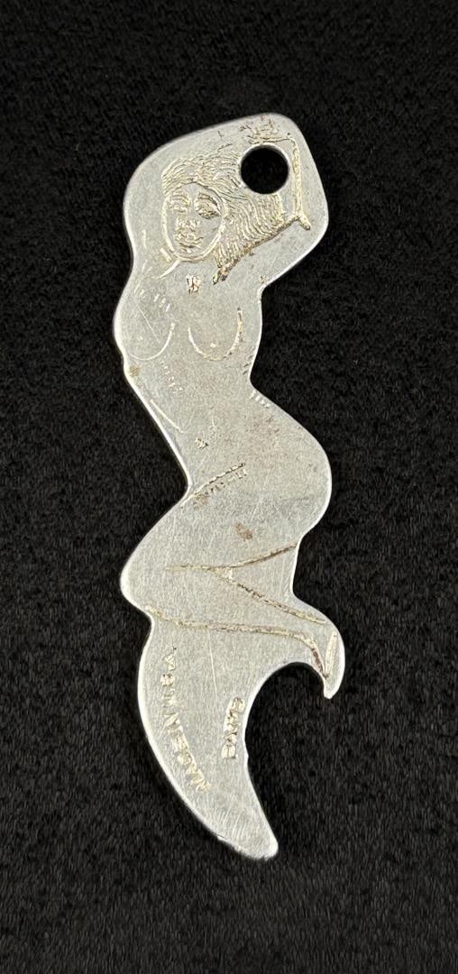Nude Log Cabin Inn Ledger Montana Bottle Opener: 2 3/4" long.