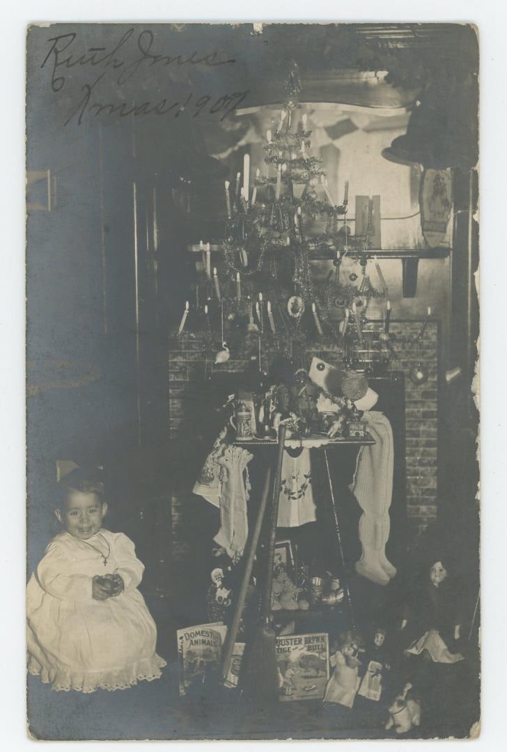 Christmas 1907 RPPC Postcard: Quite a few gifts and presents.