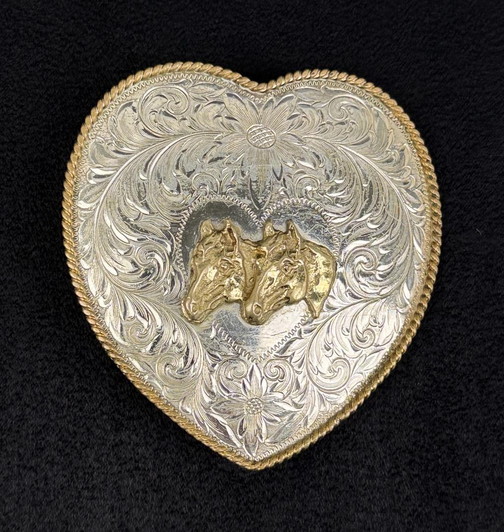 Montana Silversmiths Heart Horse Belt Buckle: German silver. Columbus, Montana. 3" by 2 7/8" by 5/8".