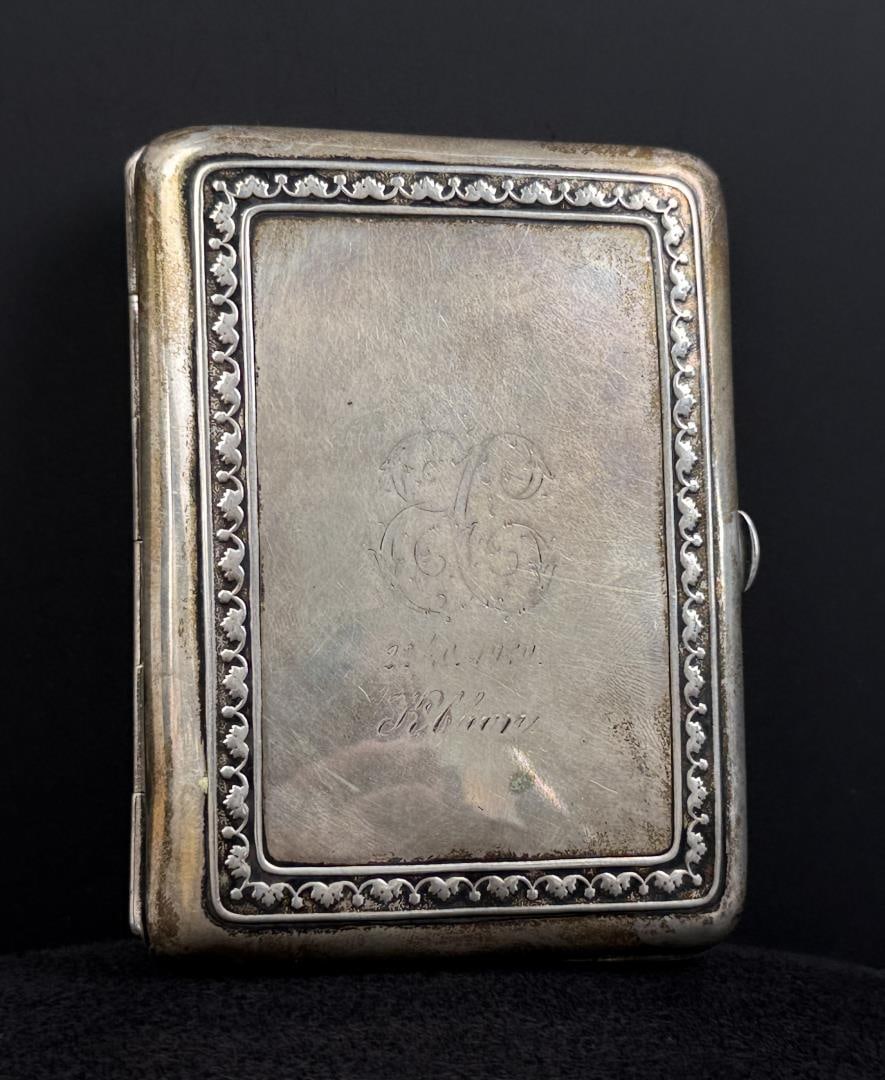 .830 Silver Engraved Cigarette Case: 3 1/2" by 2 7/8" by 7/8". 61.99 grams 830 silver.