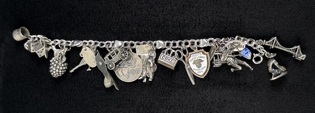 Sterling Silver Travel and Novelty Charm Bracelet: 6 1/2" internal circumference. 54.49 grams.