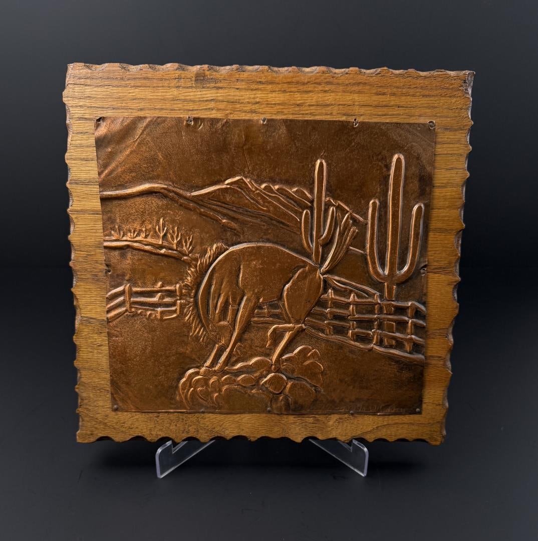 Cowboy Hammered Copper Bucking Bronc Plaque: Signed Donna Wilmoth as shown. Mounted on a wood plaque that measures 11" by 10 5/8"