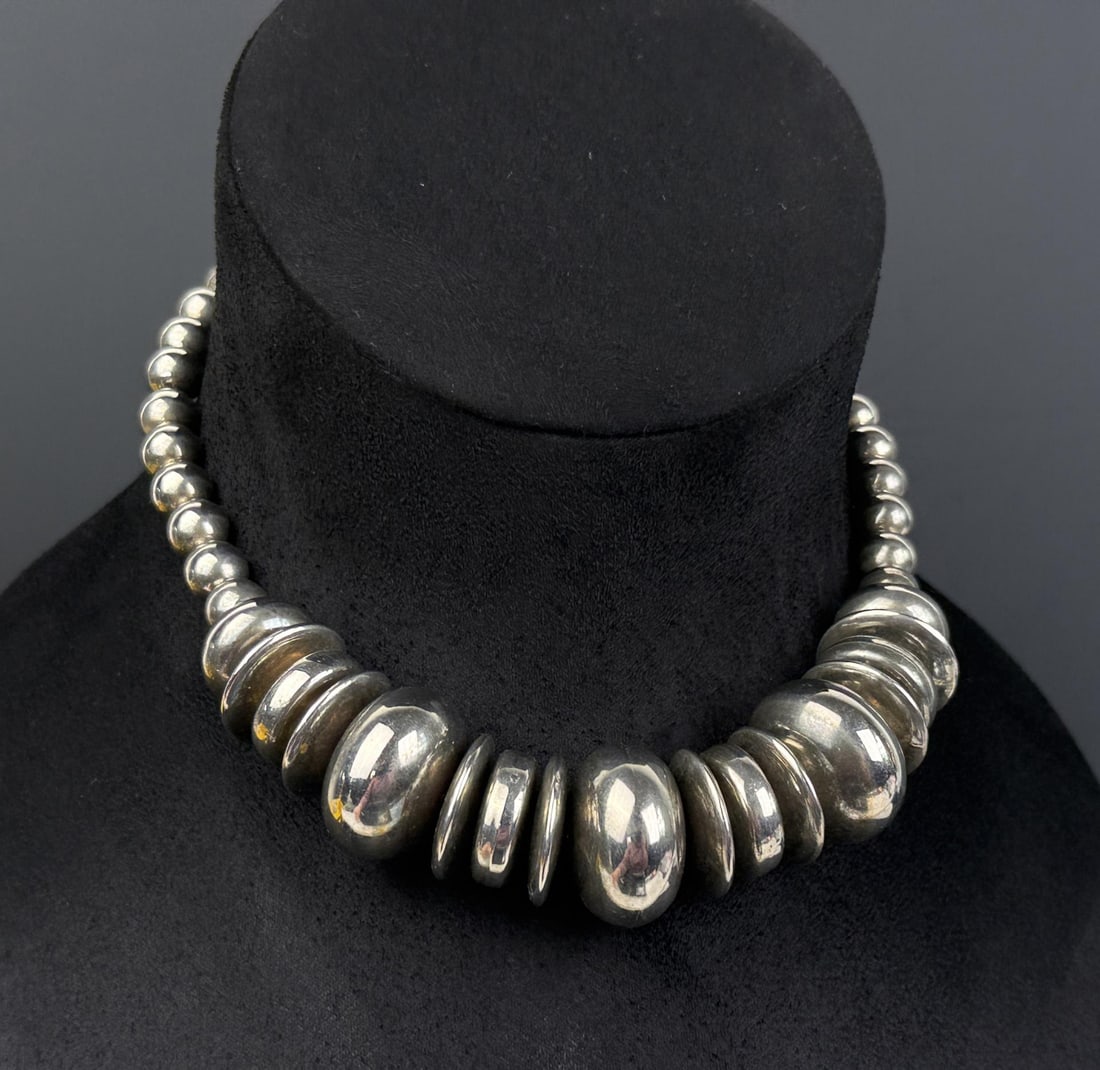 Mid Century Sterling Silver Fashion Necklace: Made to look like Navajo bench bead pillow necklace. Weighs 89 grams. Measures 11 3/4" long.