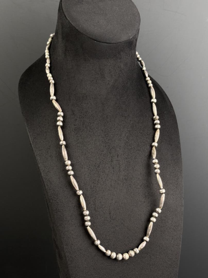 Navajo Sterling Silver Bench Bead Necklace: 14" long as displayed. 31.66 grams.
