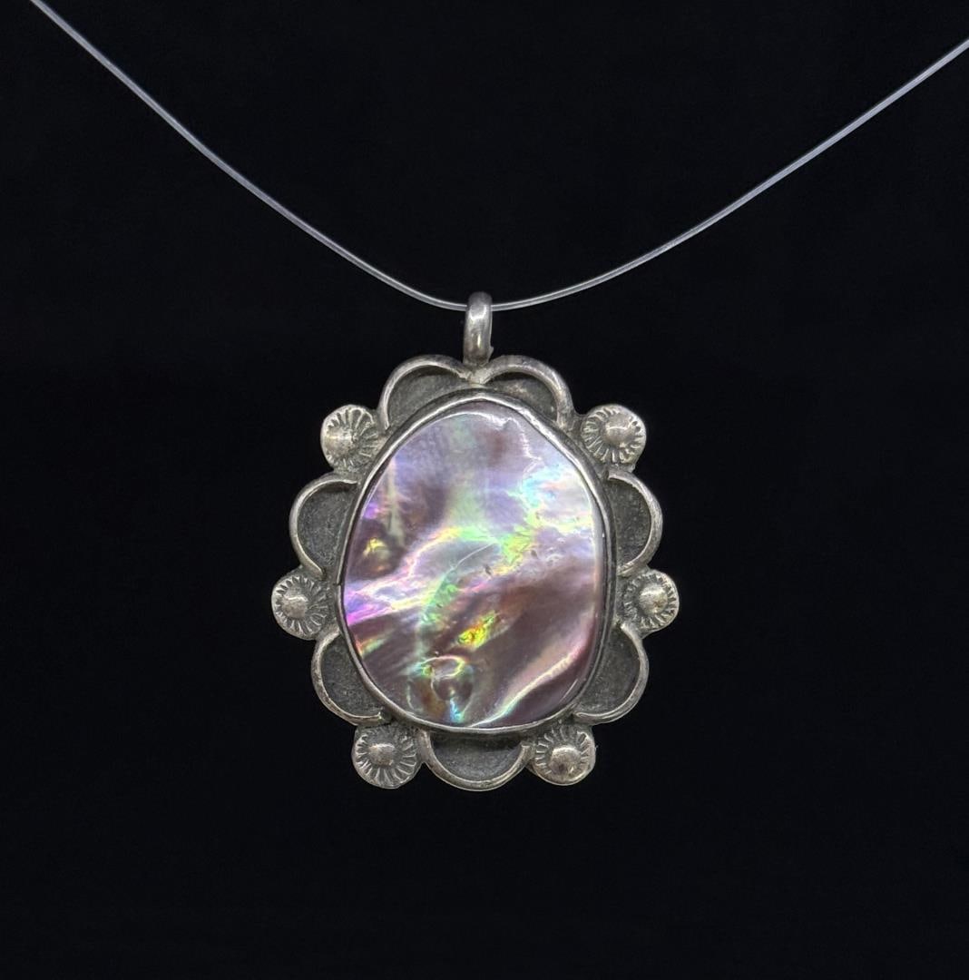 Navajo Sterling Silver Mother of Pearl Pendant: Measures 1 1/4" long. Weighs 5.81 grams.