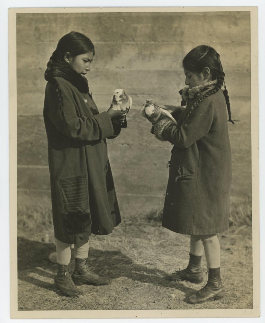 Montana Blackfoot Indians with Doves Photo: 8" by 10". Two young Native American girls holding their first and second prize pigeons, following the Midwinter Agricultural & Industrial Fair at the Glacier National Park, in northwestern Montana, o
