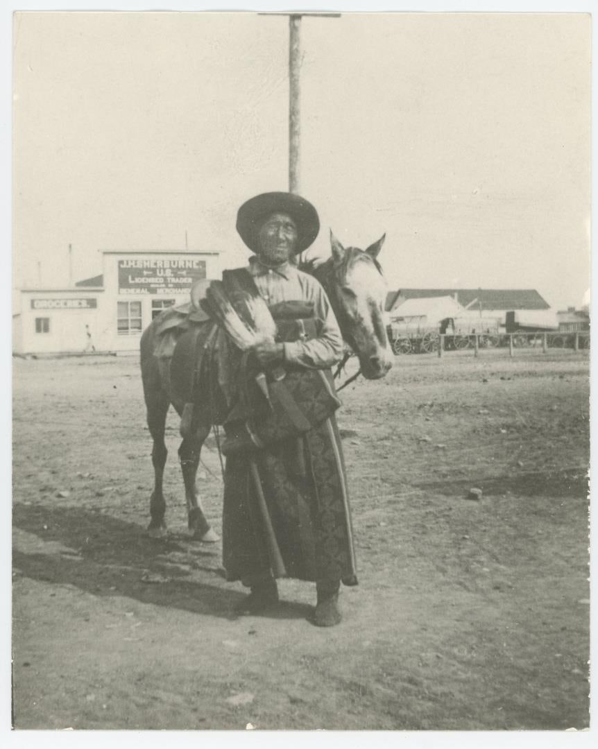 Old Morning Eagle Browning Montana Indian Photo: J.H. Sherburne Indian Trader Office in the background. 8" by 10".