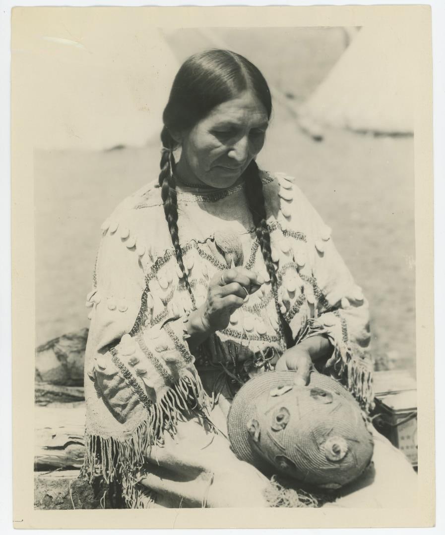 Mrs. Day Rider Blackfoot Indian Montana Photo: Mrs. Day Rider of the Glacier National Park Reservation, trims her own Easter bonnet. 8" by 10".