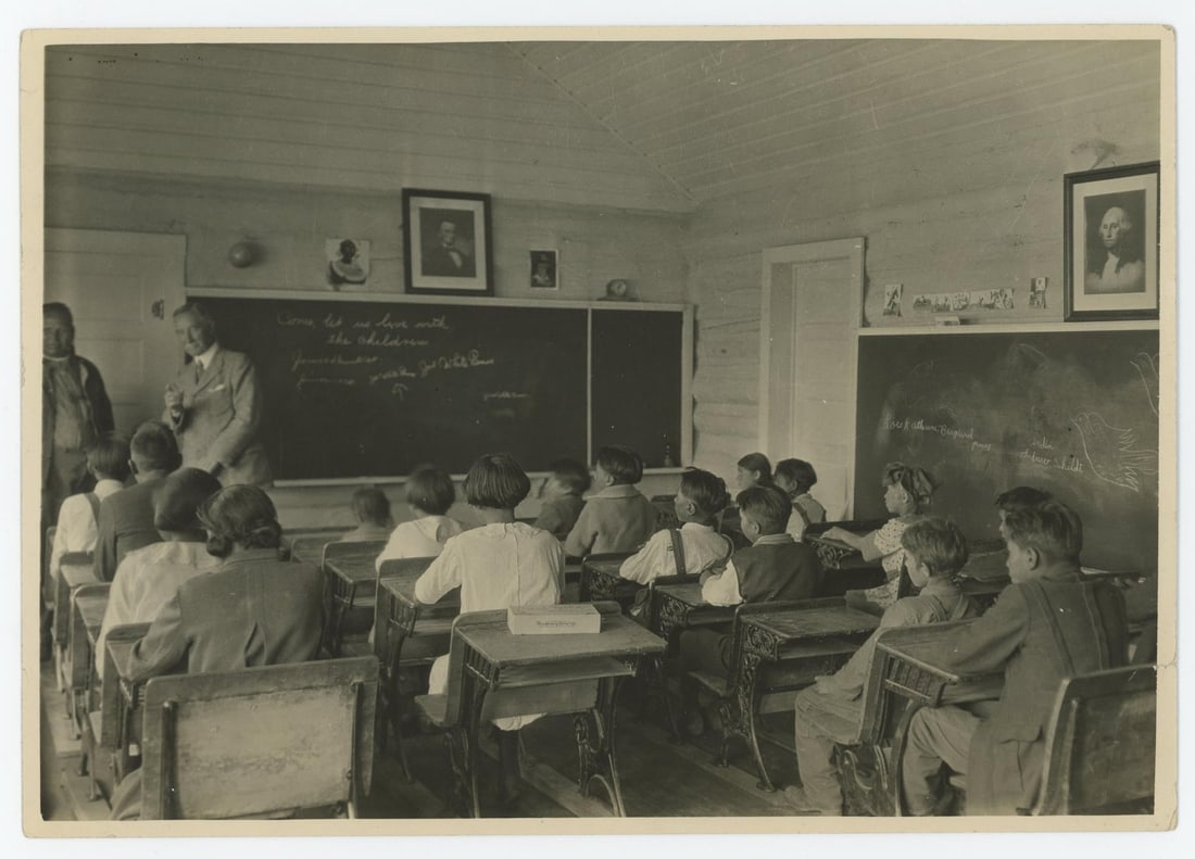 Chief Owen Heavy Breast Indian School Photo: Doctor L. Webster Fox addressing children of Chief Owen Heavy Breast School on the highway out of Glacier Park. Photographer is TJ Hileman. 7" by 10"