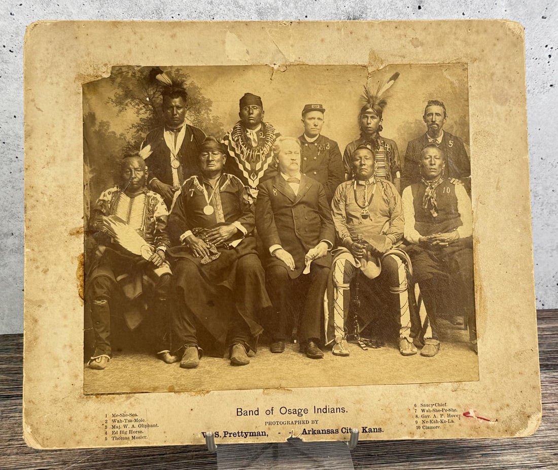 W.S. Prettyman Osage Indians Photo: 10" by 12" W.S. Prettyman, Arkansas City, KS, with imprinted title on the mount Band of Osage Indians, and numbers in the negative corresponding to the identification of each man. The white man at cen