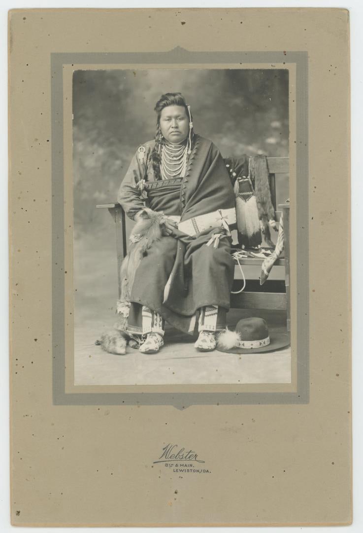 William Carter Idaho Nez Perce Indian Photo: Photographer is Webster of Lewiston Idaho. Backside says William Carter, Alute Pow Ow Yeen, or Shot in the Belly. 6" by 9" Provenance: The Larry Ness Collection of Native American Photography