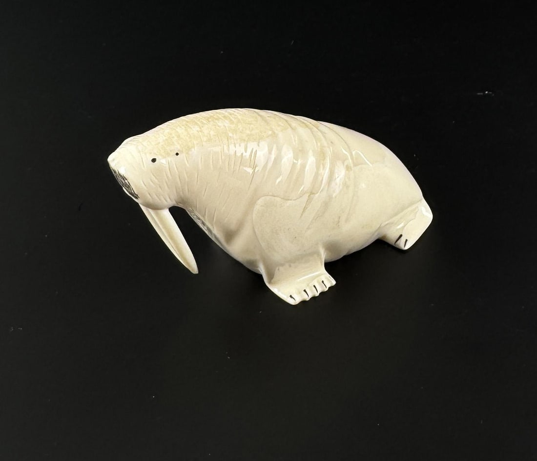 Lincoln Milligrock Alaskan Eskimo Ivory Walrus: 3 7/8" by 1 7/8" by 1 1/2". Signed. Native made prior to 1972. This item cannot be shipped to Oregon, California, Hawaii, New York, New Jersey, Internationally, or any other state that prohibits.