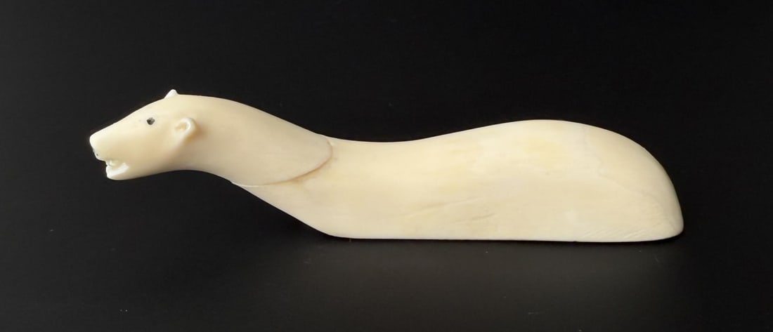Andy Mamgark Alaskan Inuit Eskimo Ivory Carving: Swimming Polar Bear. 4 7/8" by 1 1/8" by 1 1/8". Native made prior to 1972. This item cannot be shipped to Oregon, California, Hawaii, New York, New Jersey, Internationally, or any other state that pr