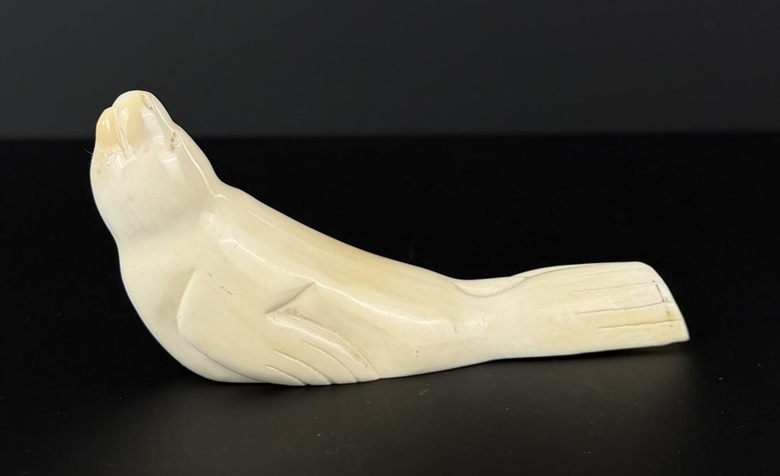 Alaskan Inuit Eskimo Carved Ivory Seal: 5 1/2" by 2 1/2" by 1 1/2". Native made prior to 1972. This item cannot be shipped to Oregon, California, Hawaii, New York, New Jersey, Internationally, or any other state that prohibits.