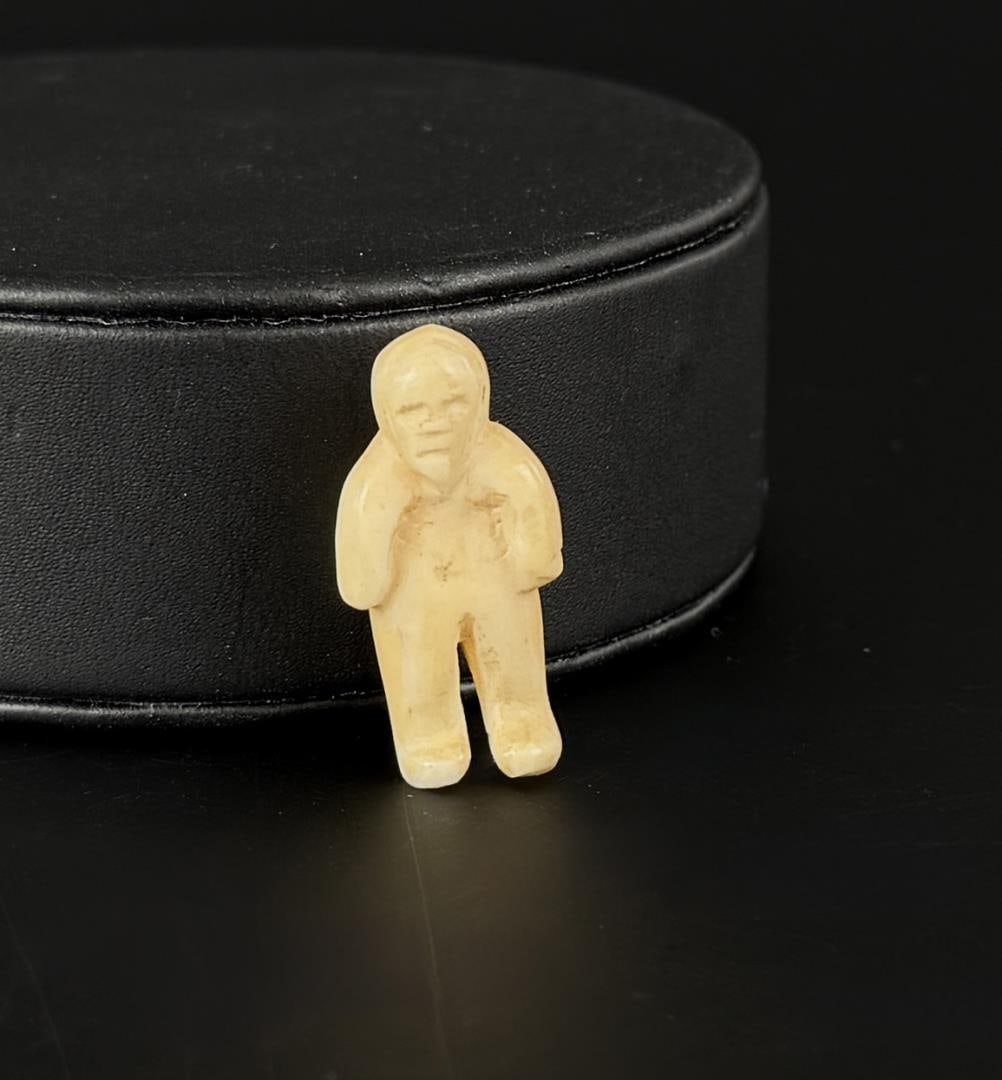 Madeleine Isserkut Kringayak Inuit Carved Mother: 1" by 1/2" by 1/2". Native made prior to 1972. This item cannot be shipped to Oregon, California, Hawaii, New York, New Jersey, Internationally, or any other state that prohibits.