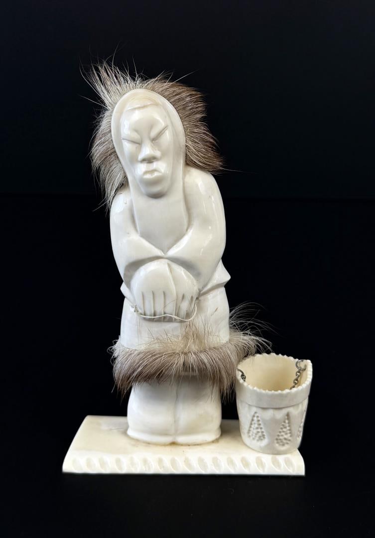 Russian Inuit Carved Ivory Woman with Bucket: 5 3/4" by 3 3/4" by 1 3/4". Native made prior to 1972. This item cannot be shipped to Oregon, California, Hawaii, New York, New Jersey, Internationally, or any other state that prohibits.