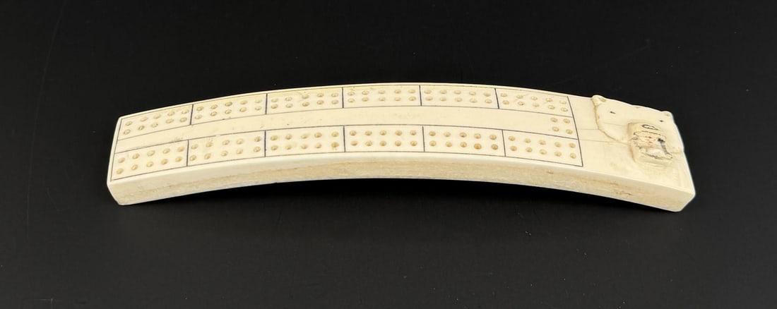 Alaskan Inuit Eskimo Walrus Ivory Cribbage Board: 7 1/2" by 1 1/2" by 7/8". Native made prior to 1972. This item cannot be shipped to Oregon, California, Hawaii, New York, New Jersey, Internationally, or any other state that prohibits.