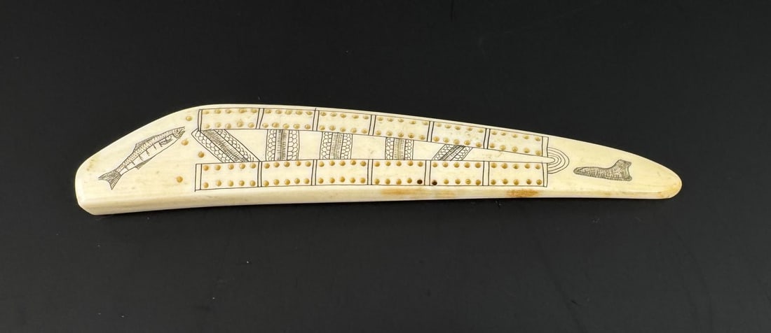 Alaskan Inuit Eskimo Walrus Ivory Cribbage Board: 6 1/2" by 1 1/8" by 1/2". Native made prior to 1972. This item cannot be shipped to Oregon, California, Hawaii, New York, New Jersey, Internationally, or any other state that prohibits.