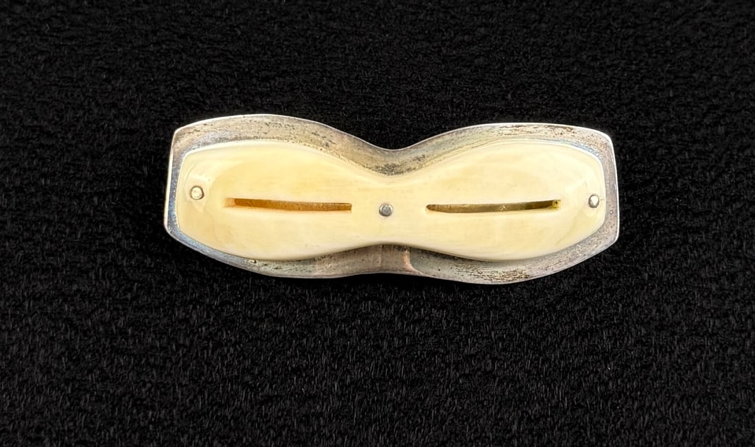 Alaskan Inuit Eskimo Ivory Snow Goggles Brooch: Set in Sterling Silver. Not signed. 1 3/4" by 1/2". Possibly the work of Denise Wallace.