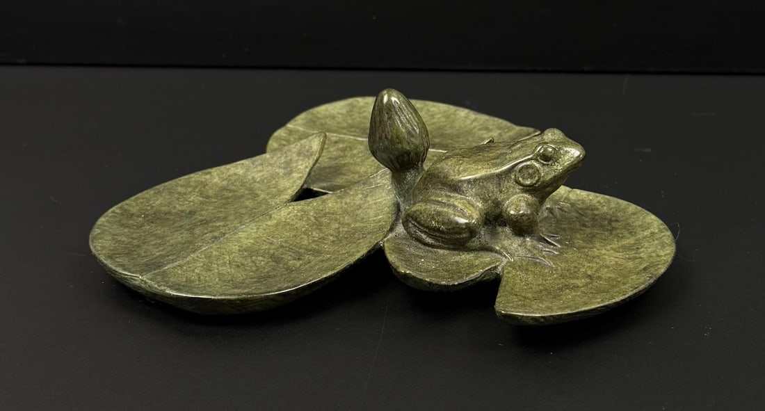 Tony Hochstetler Frog on Lilly Pads Bronze: Title is Frog on Lilly Pads. Edition 5/21. 5 1/2" by 5 1/2" by 1 1/2". Tony Hochstetler. Born 1964 Indiana. Known for: Realistic sculpture-fish, reptiles and amphibians. Sculptor Tony Hochstetler is