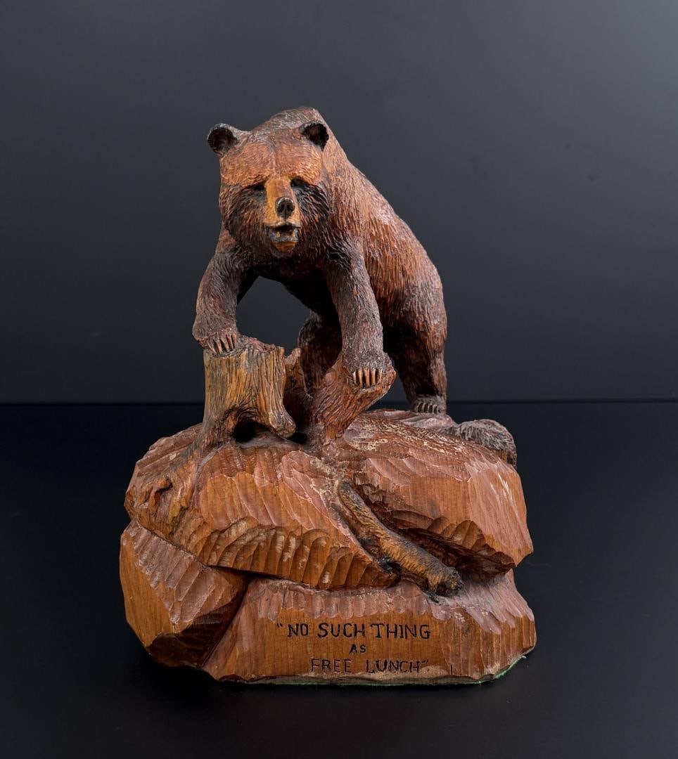 Henry Larum Bear Carving Glacier Park Montana: Title is No Such Thing as Free Lunch. 9" by 7 7/8" by 7". Today, Larum is known throughout the country as a master wood and antler carver who has works in the possession of collectors and in the hands