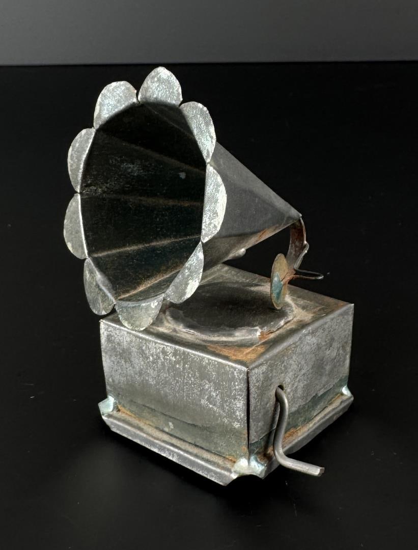 Tin Lithograph Phonograph Music Box: 3 1/4" by 2 7/8" by 2 1/2". In working condition.