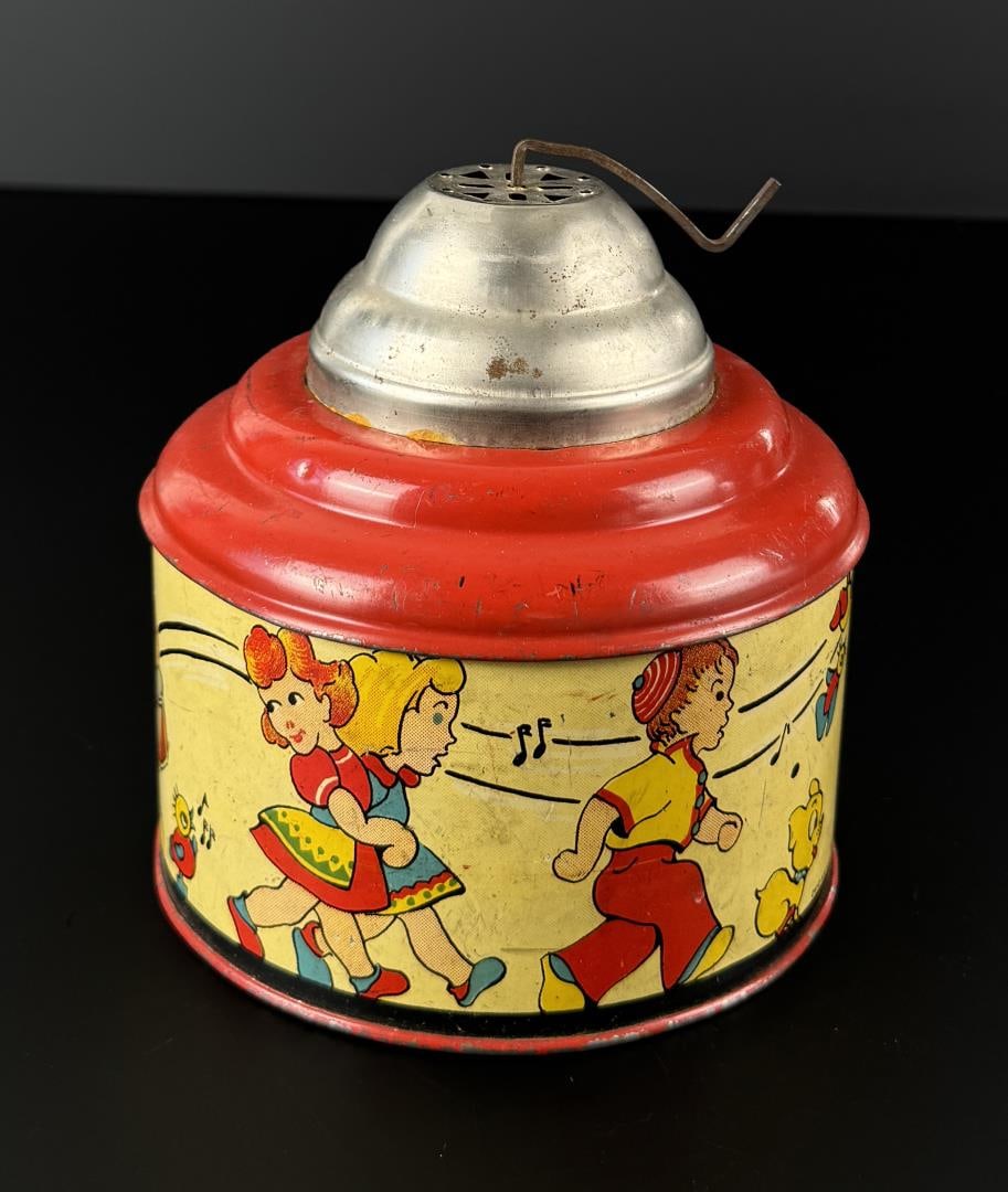 1940s Ohio Art Co Tin Litho Wind Up Music Box: 5 1/4" by 5 1/4" by 5 1/4". In working condition.