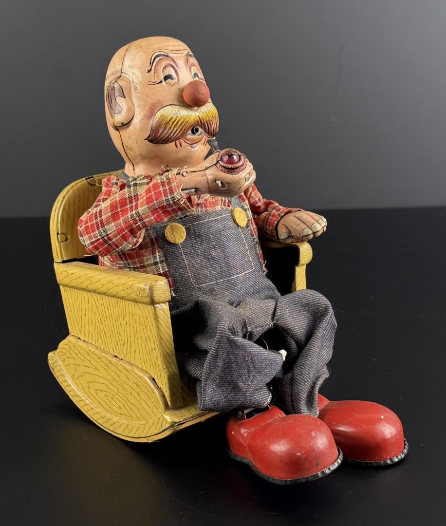 1950s Marusan Smoking Grandpa Litho Toy: 7 7/8" by 7 1/2" by 4 7/8". Pipe lights up and steam comes out of mouth, but he does not rock in his chair.