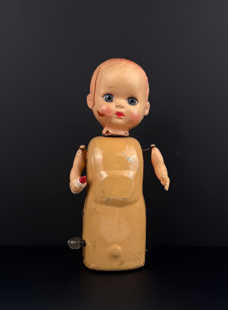 Japan Mechanical Wind Up Baby Doll Tin Toy: In working condition. Rough shape.