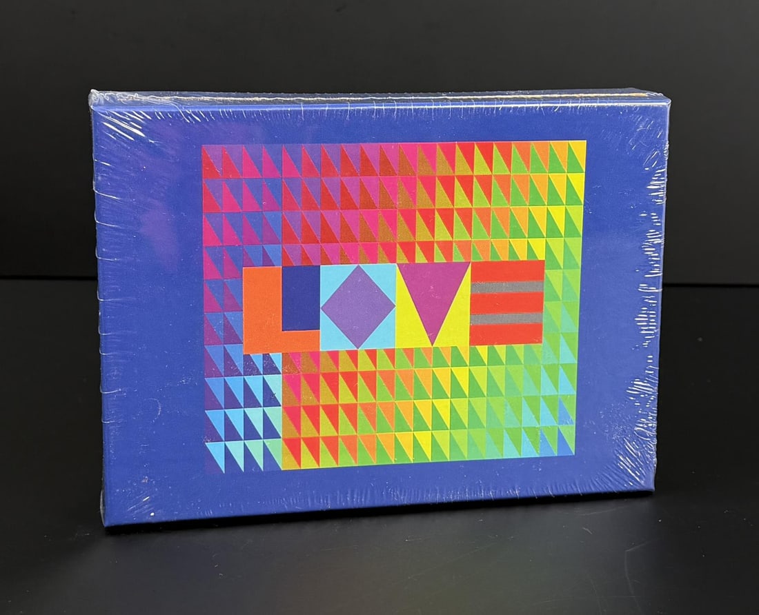 Jeffrey Gibson Love Wood Puzzle Sealed: From the Brooklyn Museum, 104 piece wood puzzle, 8" by 10". Jeffrey Gibson (born 1972) is a contemporary Indigenous American artist of Choctaw and Cherokee heritage known for vibrant mixed-media