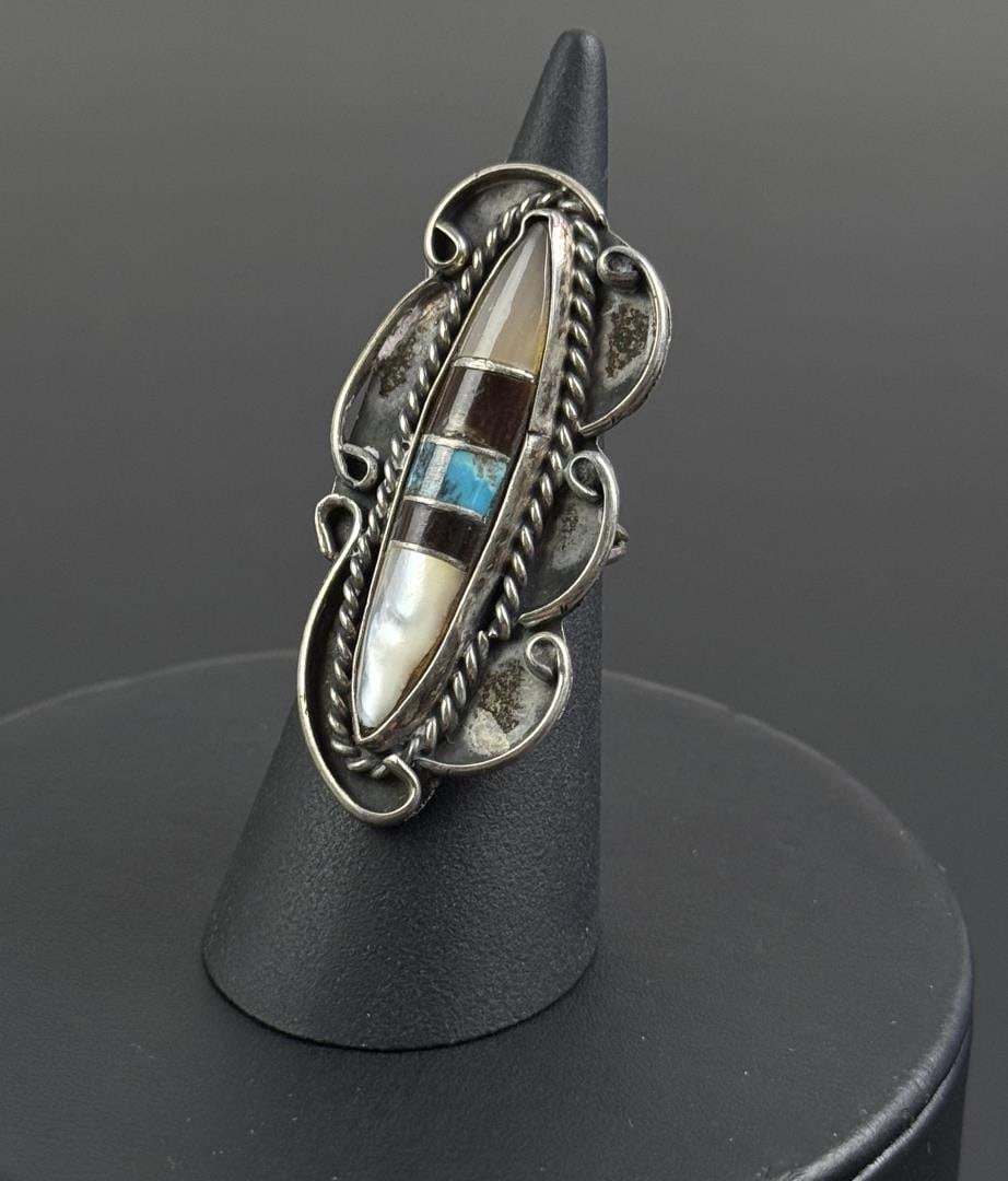 Zuni Sterling Silver Inlay Ring: Size 6. 8.4 grams. Stones include Turquoise, Mother of Pearl and Onyx.