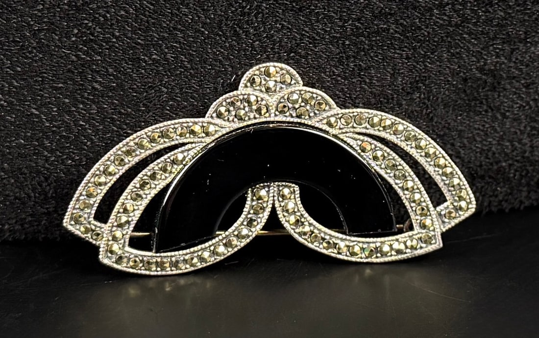 Sterling Silver Onyx Marcasite Brooch: 2 1/4" by 1 1/4" by 1/4". 13.61 grams.