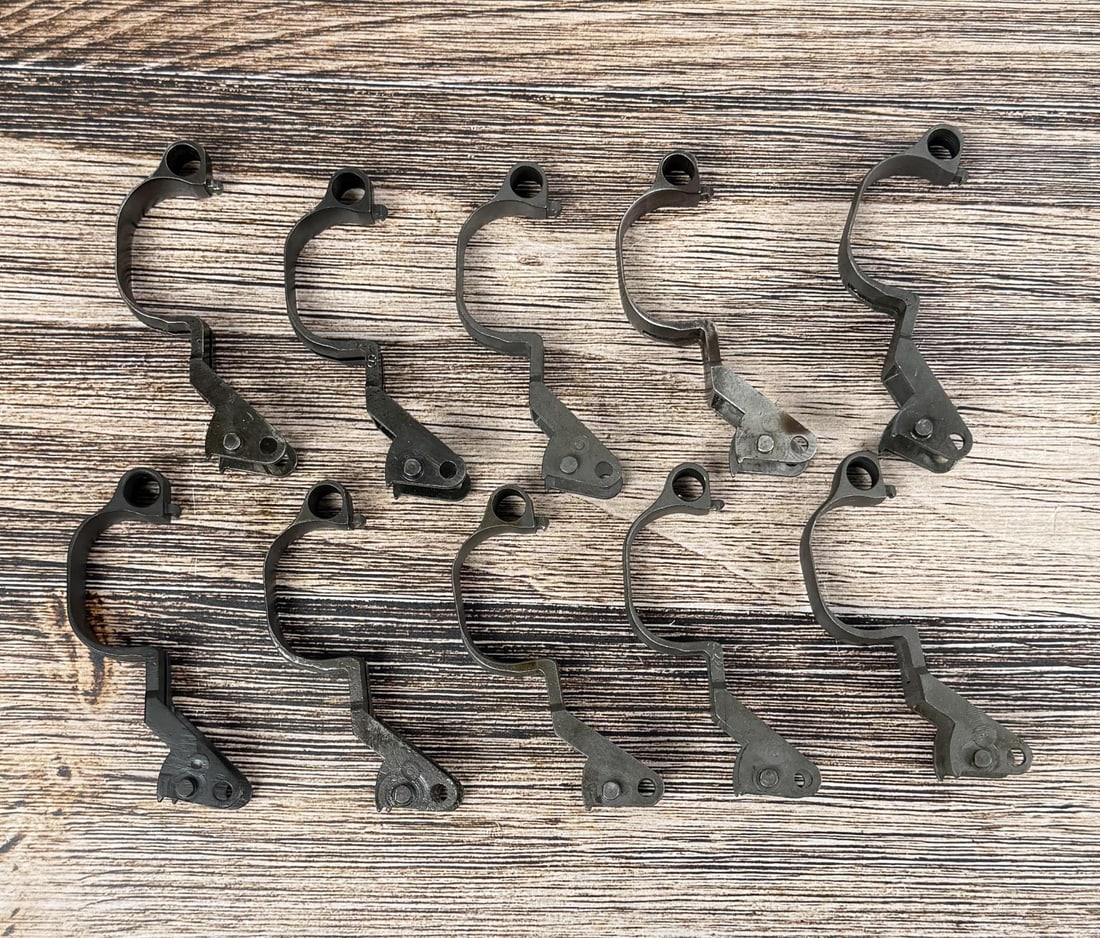 M1 Garand Milled Trigger Guards: 10 total. 3 are marked "2", 3 are marked "7", 2 are marked "S", and 2 are marked "C46025W.R.A.".