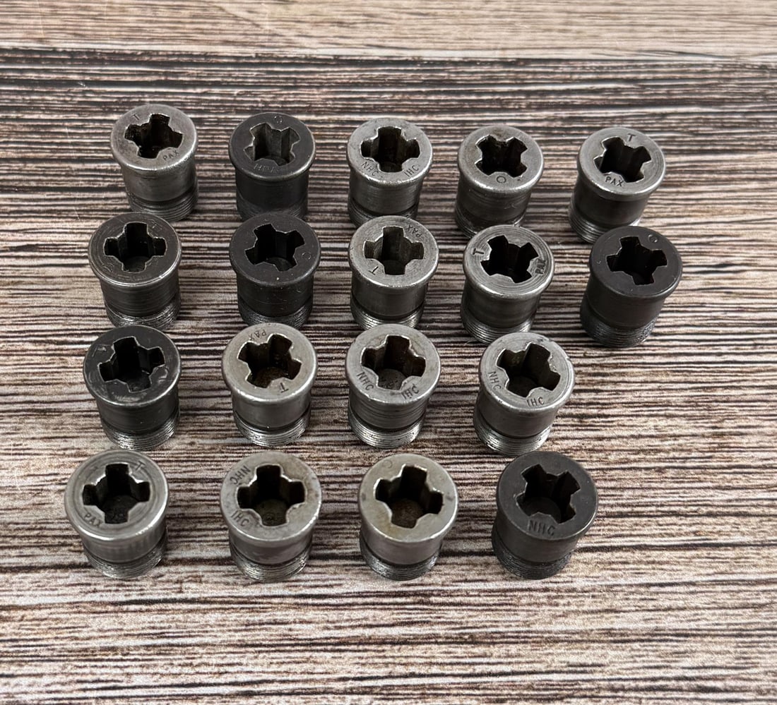 M1 Garand Gas Cylinder Lock Screws: 18 total. 6 are marked "T PAX", 4 are marked "NHC IHC", 4 are marked "O", 1 is marked "P" with a hexagon logo, 1 is marked "O HRA", 1 is marked "PP" with a hexagon logo, and 1 is marked "NHC".