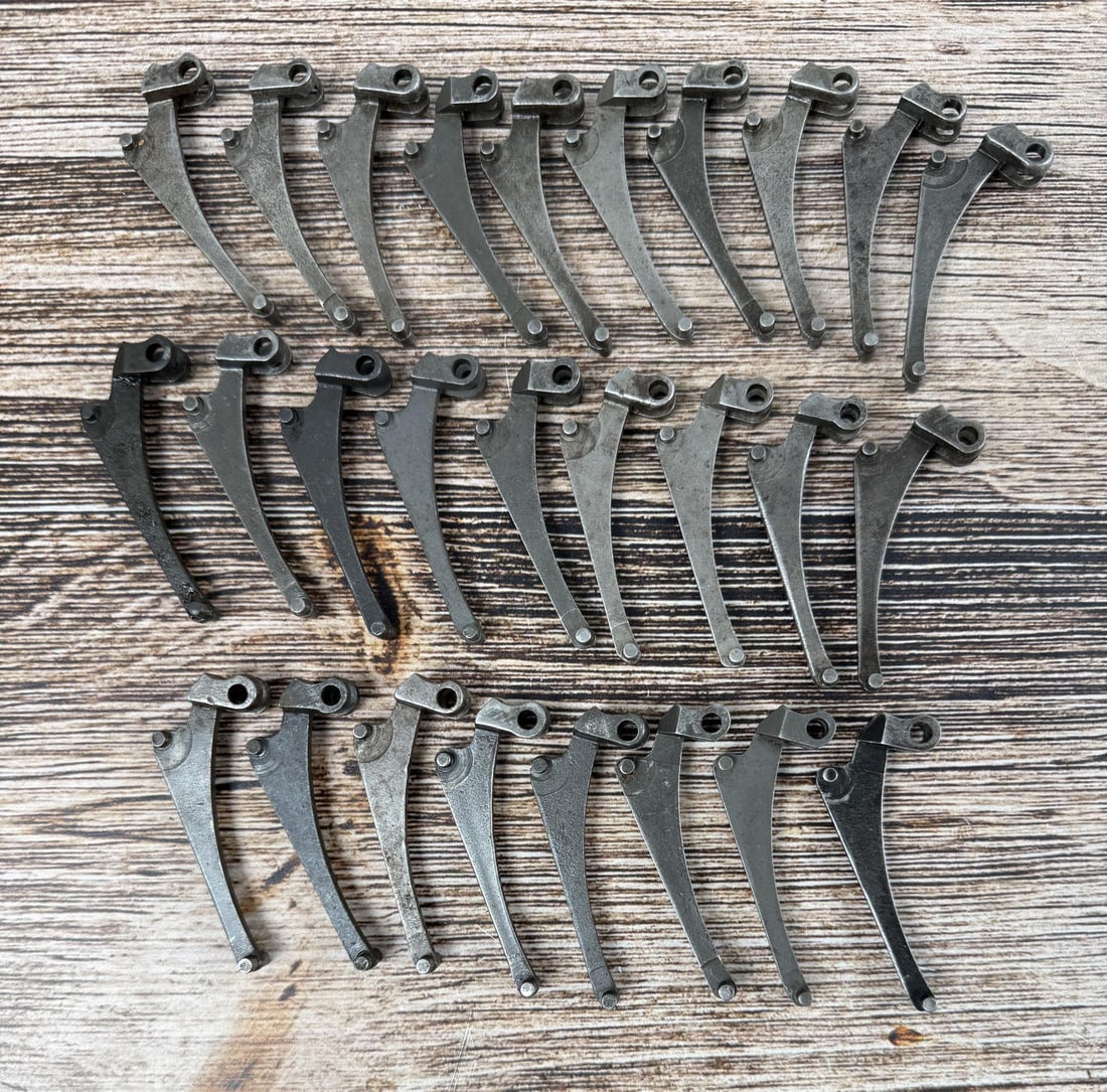 M1 Garand Follower Arms: 27 total. 1 is marked "PB", 1 is marked "2S", the rest are unmarked.