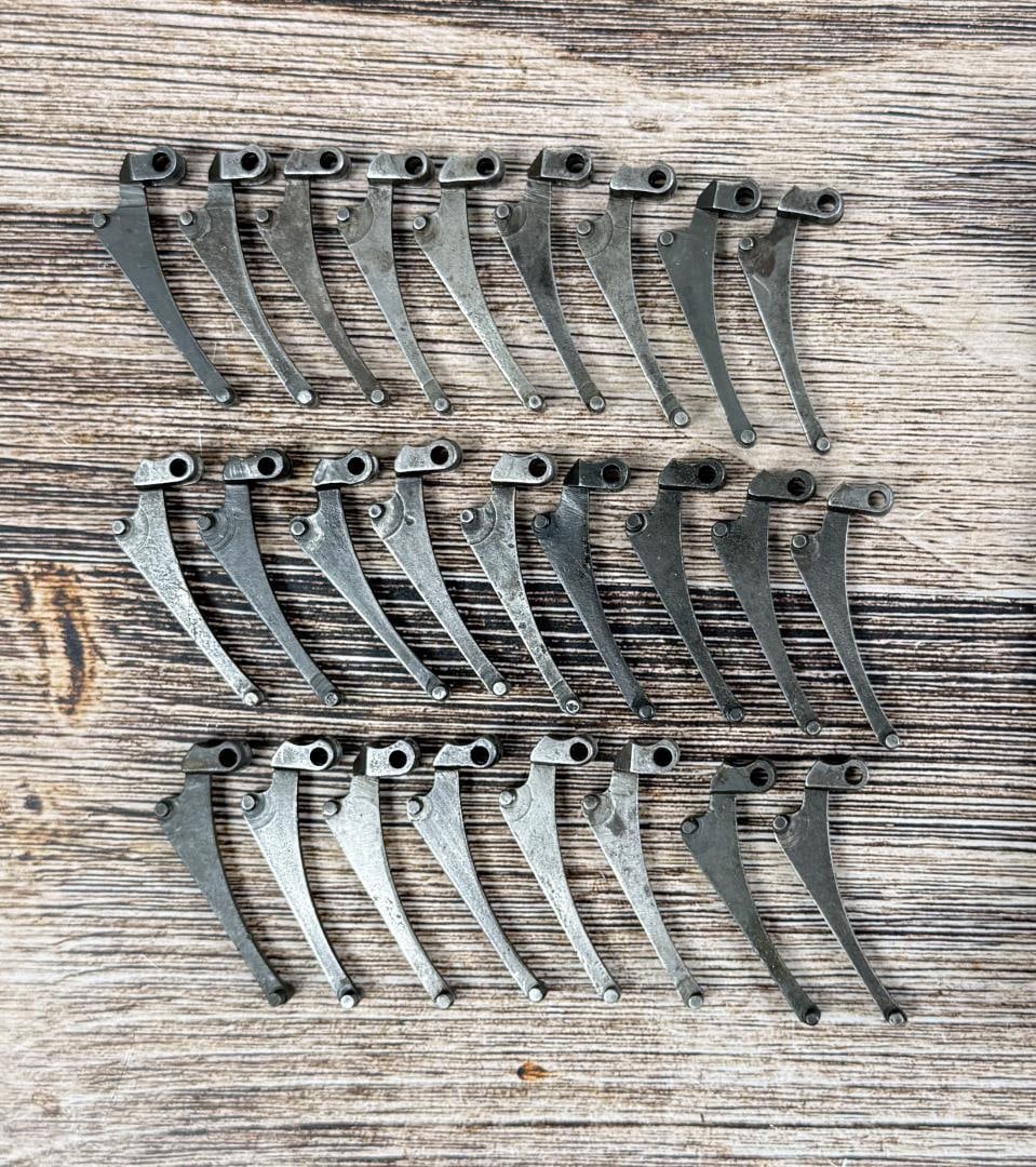 M1 Garand Follower Arms: 26 total. 2 are marked "S2", 3 are marked "97S2", 1 is marked "6", 1 is marked "28", and the rest are unmarked.