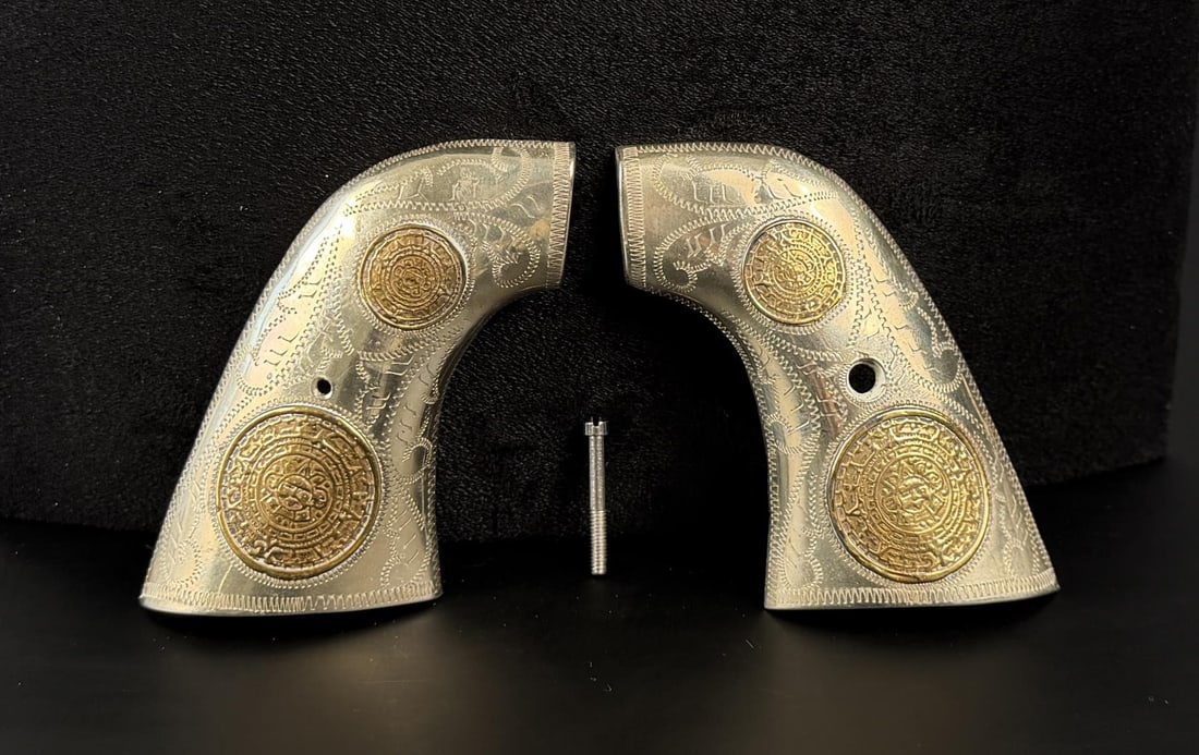 Mexico Sterling 10k Gold Colt Single Action Grips: Single Action Army. Mexican Calendar Pattern. Sterling Silver and 10k Gold. 91.96 grams total weight.