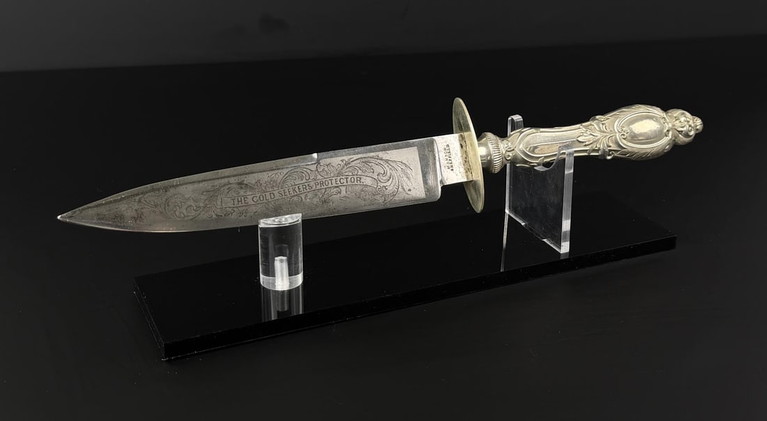 Manson The Gold Seekers Protector Bowie Knife: 13" long. Provenance: Cowan's Auction May 2, 2018, lot 1307, sold price $3,000.
