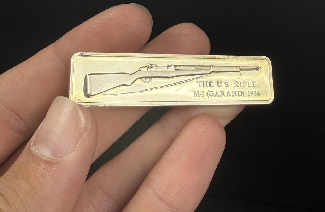 Lincoln Mint US M-1 Garand Rifle 1oz Silver Bar: Issue No. 13 of the American Weapons Hall of Fame by the Lincoln Mint. The United States Rifle .30 Caliber, Model M-1 Garand. 31.04 grams of 24K Gold Plated Silver. Measures 2 1/2" by 5/8"