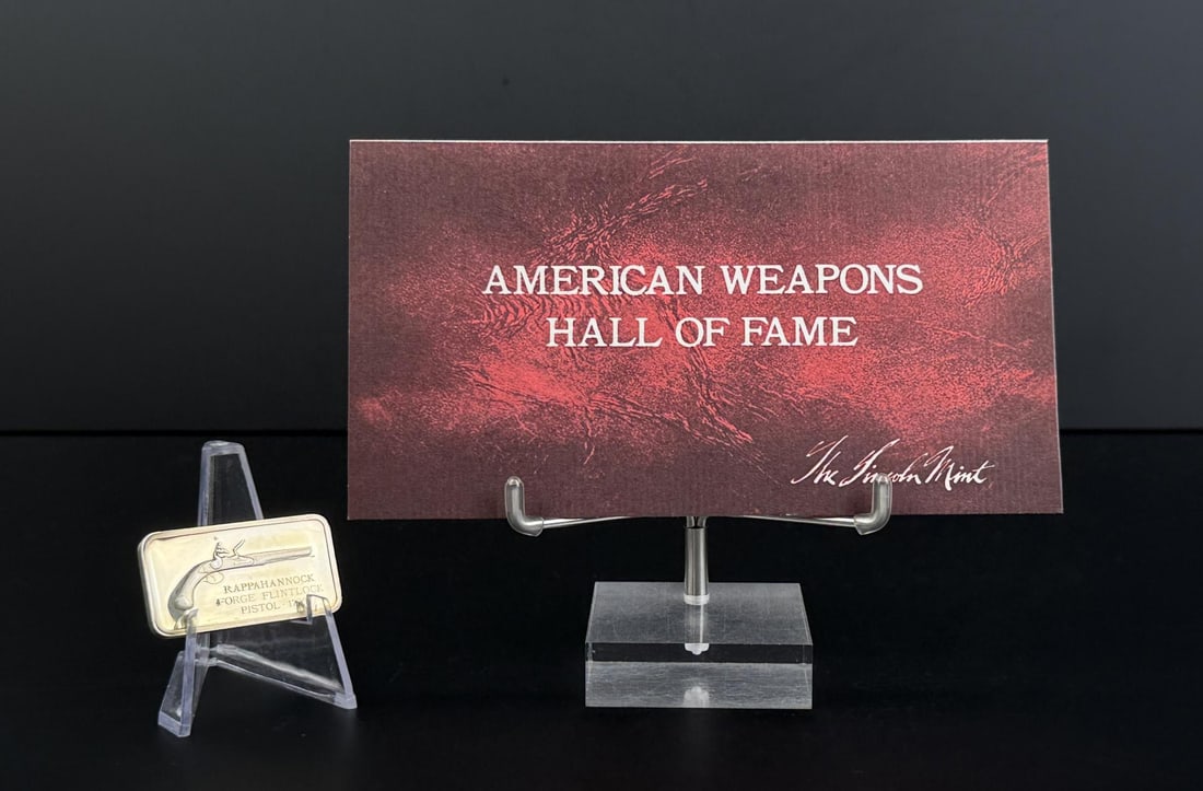 Lincoln Mint Flintlock Pistol 1780 1oz Silver Bar: Issue No. 29 of the American Weapons Hall of Fame by the Lincoln Mint. The Rappahannock Forge Flintlock Pistol of 1780. 32.77 grams of 24K Gold Plated Silver. Measures 1 5/8" by 7/8"