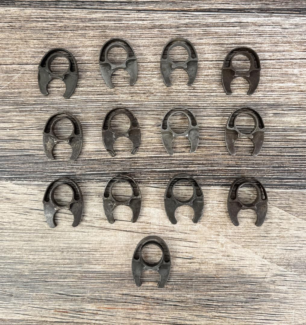 M1 Garand Milled Lower Handguard Bands: 13 total. 2 with illegible stamping, the other 11 are unmarked.