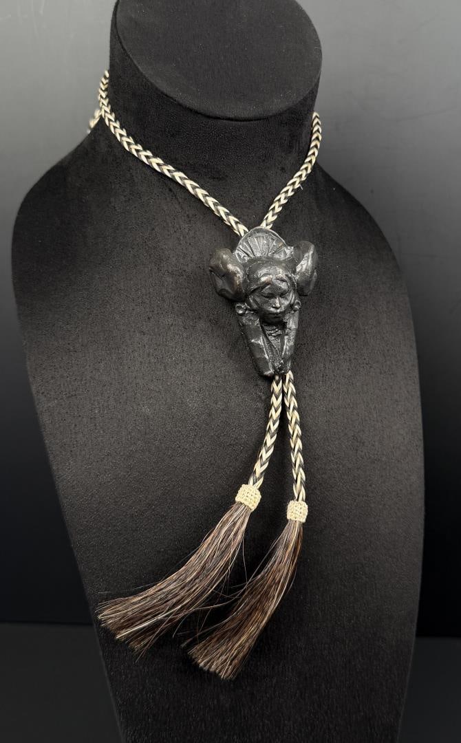 George Carlson 1997 Prix de West Bronze Bolo Tie: Title is Hopi Maiden. 19 1/4" long George A. Carlson (Born 1940) is active/lives in Idaho, Illinois, Colorado. George Carlson is known for Landscape painting, sculpture and drawing. George Carlson cre