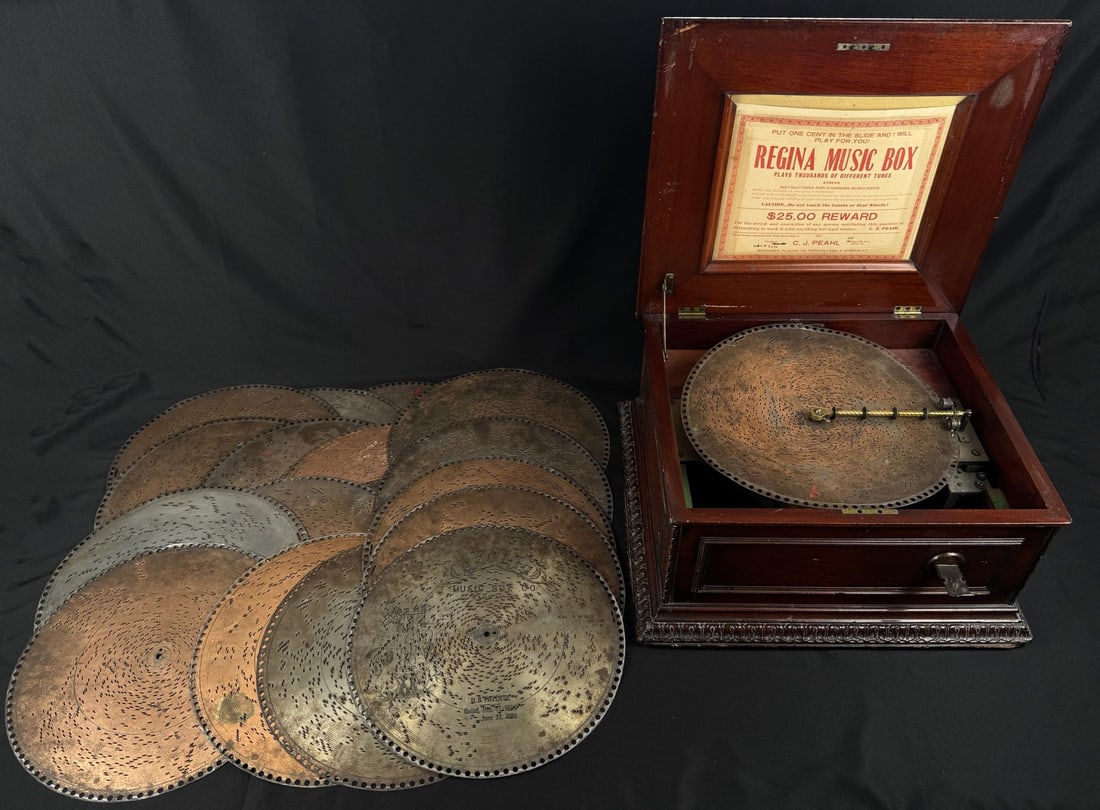 Regina Coin Operated Disc Music Box: Quite Scarce. Working Condition. Comes with 18 total discs. 20" by 22" by 12".