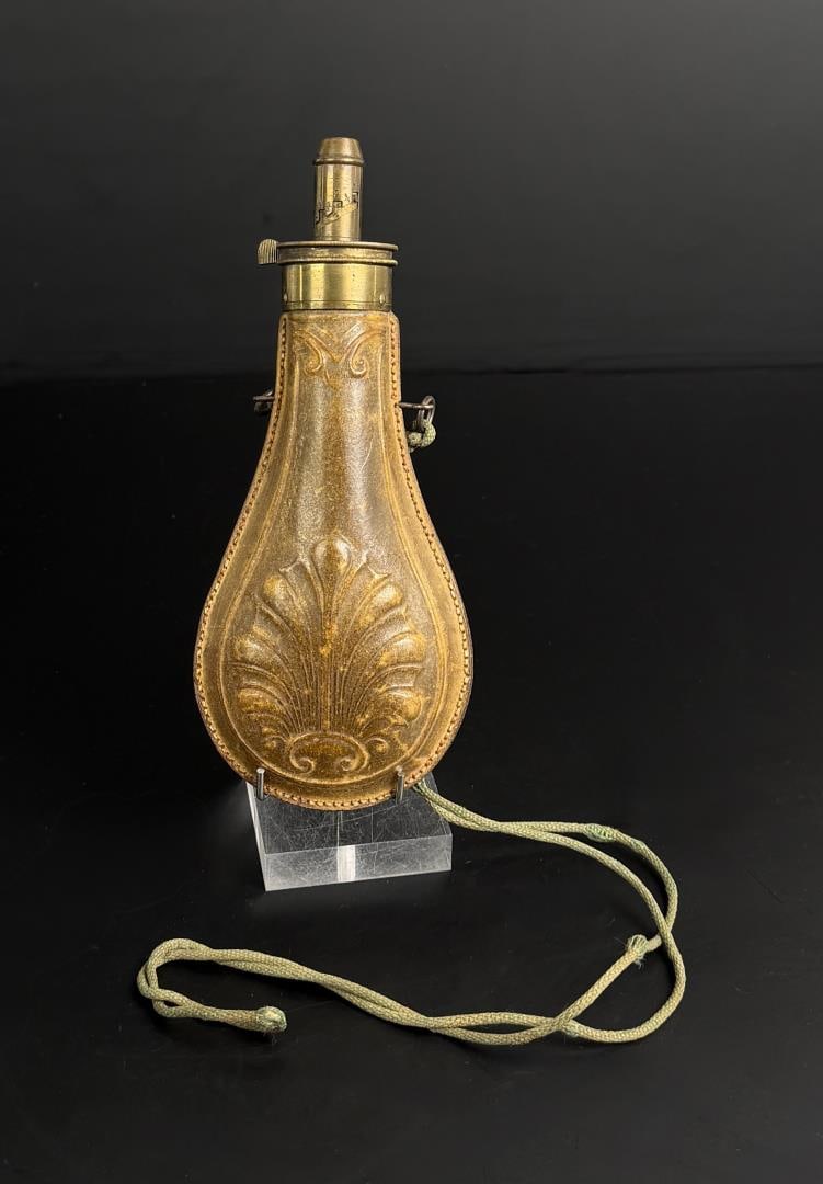 Leather Covered Shell Pattern Powder Flask: Nice example. 8" long.