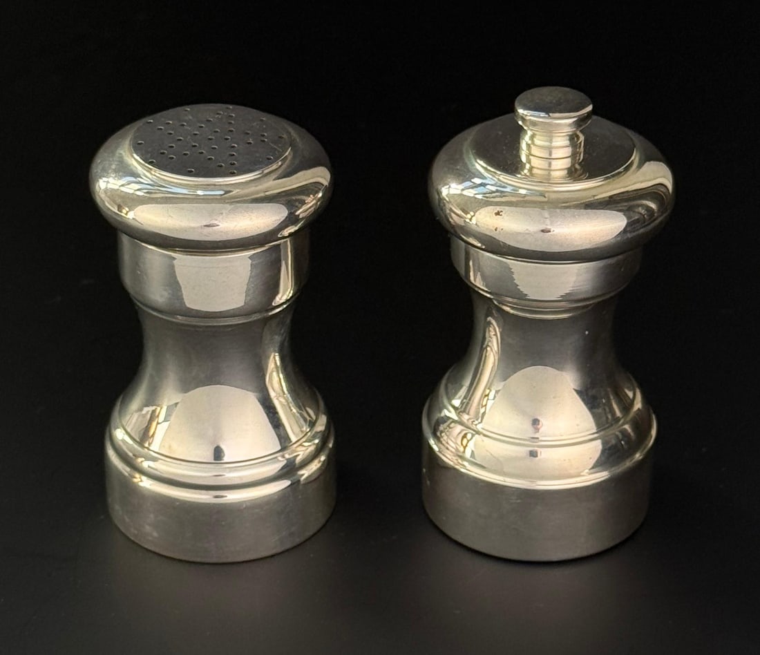 Tiffany & Co Sterling Salt Shaker Pepper Mill: 23977 and 22988 patterns. Sterling Silver set, 336 grams. Largest measures 3 5/8 tall and 2" in diameter.