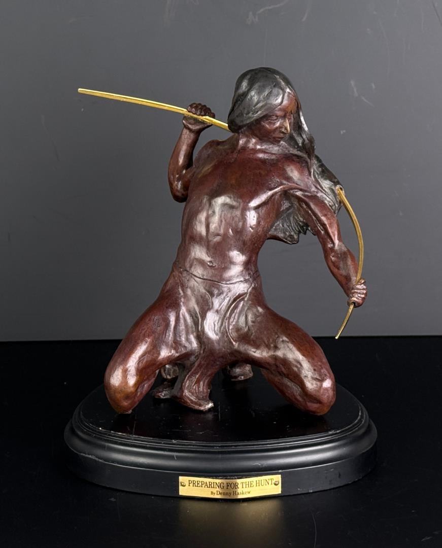 Denny Haskew Preparing for the Hunt Bronze: Title is Preparing for the Hunt. 10 3/8" by 9" by 8 5/8". Denny Haskew. Born 1948. Known for: Sculptor-Indian figure. Denny Haskew had always worked with his hands building furniture and creating stai