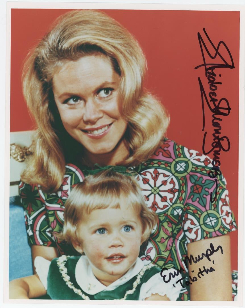 Elizabeth Montgomery Signed Bewitched Photo: Elizabeth Montgomery who played Samantha Stephens on the popular 1960s-1970s show Bewitched and Erin Montgomery who played her daughter, Tabitha Stephens both signed this promotional photograph. 8" by